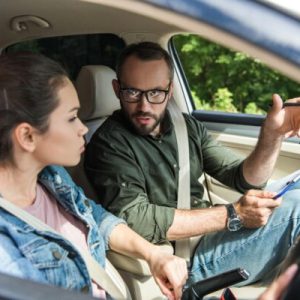 teacher-pointing-on-something-to-student-in-car-du-2021-08-29-22-36-11-utc-600x400